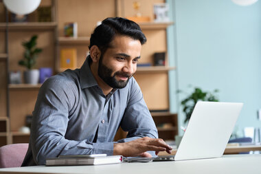 Man on laptop computer at his home