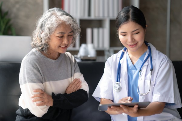 A doctor and their patient look at a survey together.  